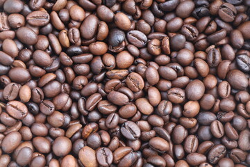 Photo of Big pile of fresh roasted coffee beans close up. Food photo for backdrops or recipes