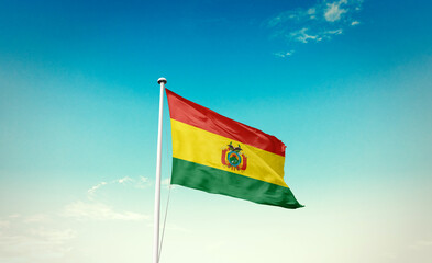 Bolivia national flag waving in blue sky.