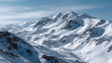 A breathtaking vista of snow-capped mountain peaks under a vibrant, clear sky.