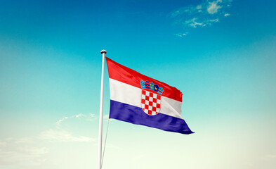 Croatia national flag waving in blue sky.