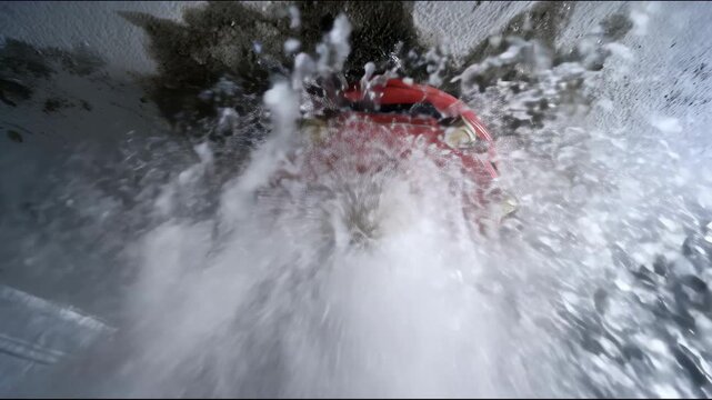 Water spraying forcefully from red fire sprinkler on ceiling during fire suppression activation