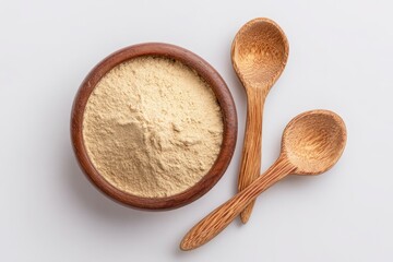Light-tan powder in a wooden bowl with wooden spoons