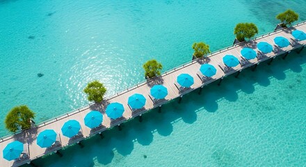 Aerial view of a wooden pier with blue umbrellas over turquoise water