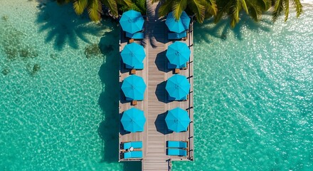 Topdown view of a pier with blue umbrellas and lounge chairs