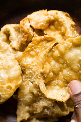 Overhead view of dublan northern nigerian snack, top view of dublan on a plate, flaky fried dough coated in syrup and sesame