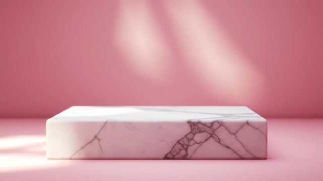 A white marble block sits centered on a pink surface against a rosy backdrop. Light falls, casting shadows, creating a sleek presentation