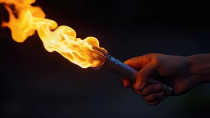 A person holding a lit torch, great for use as an atmospheric element or symbol of guidance