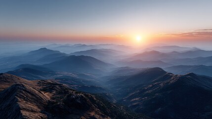 A breathtaking vista of mountain ranges at sunrise, showcasing a tranquil and serene landscape with layers of misty peaks.