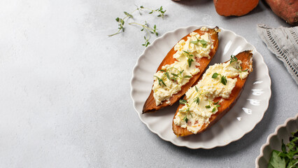 Baked sweet potatoes with ricotta and fresh herbs. Healthy and vegan food. Copy space