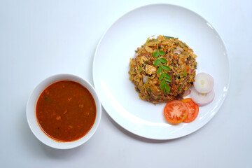 Hot and Spicy Chicken Kottu with Bowl of Gravy and Cutlery.
