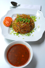 Traditional Sri Lankan Kottu with Chicken Gravy and Curry Leaves.