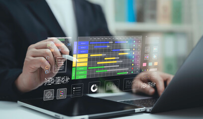 Businessman using laptop and stylus with digital project management dashboard Gantt chart and data analytics. Concept of business planning teamwork productivity and workflow