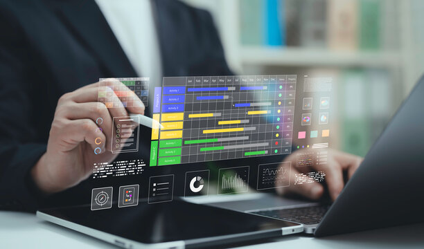 Businessman using laptop and stylus with digital project management dashboard Gantt chart and data analytics. Concept of business planning teamwork productivity and workflow