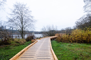 Elevated wooden walkay in Burnaby Deer Lake Park, BC, Canada