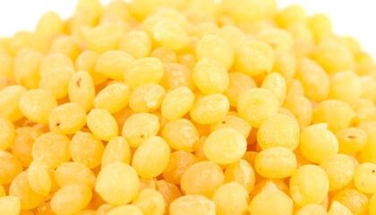 Close-up view of a multitude of small, bright yellow, round food items densely packed together.