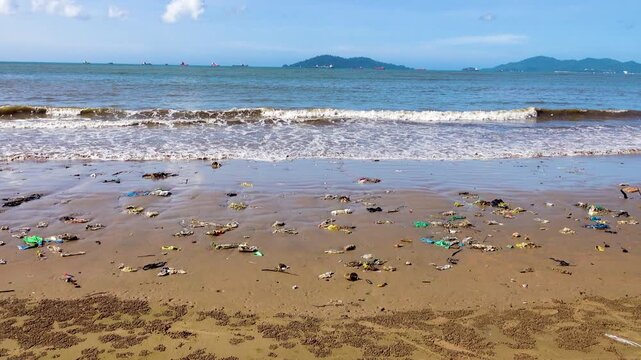 There are a lot of plastic bags in the surf strip of the sandy beach. The Sulu Sea