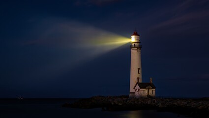 Majestic lighthouse beam pierces the night sky guiding ships safely through the darkness