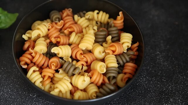 Pasta trottole tricolor pasta spiral dish twisted Italian food tasty snack fresh delicious gourmet food background on the table rustic top view copy space  vegan and vegan food
