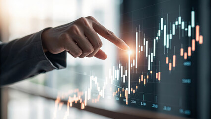 Business hand pointing at digital financial chart, stock market analysis, investment growth, and data visualization concept, modern office background, success and opportunity