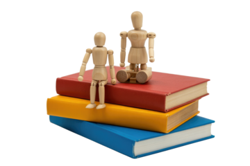 Two wooden artist's mannequins sit atop a stack of three colorful books, against a transparent background. background removed