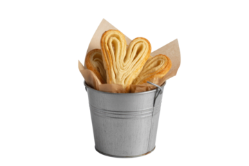 Heart-shaped palmier cookies in a small metal bucket, isolated on transparent background. background removed