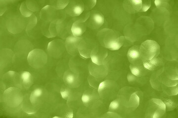 Fototapeta premium Green bokeh background with circular light patterns and soft focus for textured abstract design.