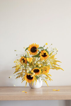 summer bouquet with sunflowers on wooden table