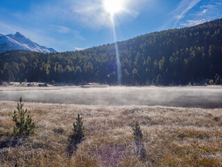 St. Moritz, Switzerland - October 6th 2024: Idyllic lake Lej da Staz in the morning sunlight