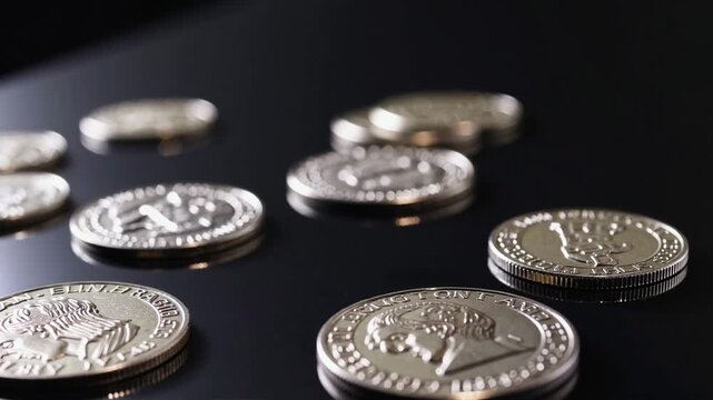 direct overhead shot of various coins including euros and cents placed on solid black background, related to online shopping and finance