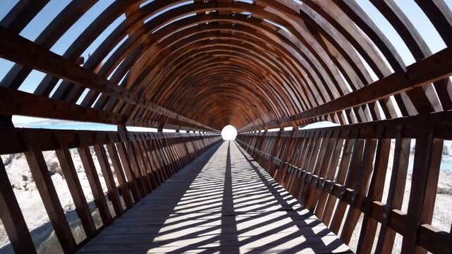 long wooden tunnel structure with strong perspective view leading to light at the end, graphed in Antalya, Turkey