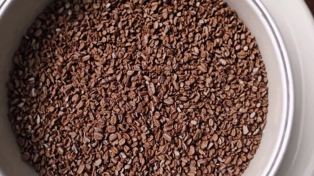 Top-down close-up graphic view of ground coffee beans showcasing texture and detail texture