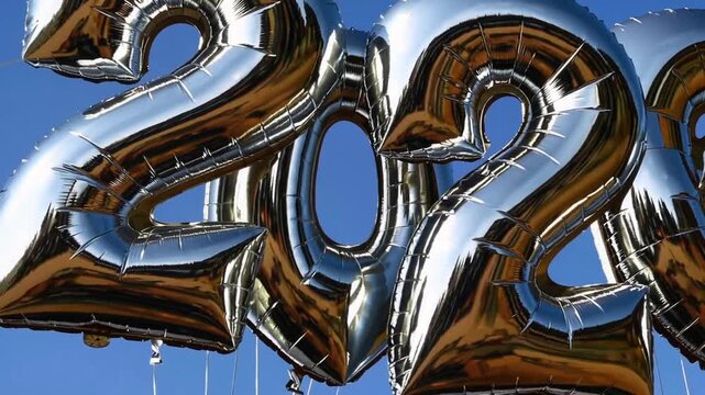 Festive Metallic Number Inflatable Decorations Against Azure Sky for Year-End Celebrations