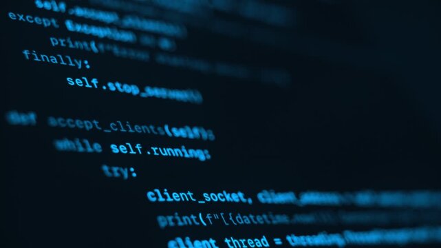 Close up of blue programming code running on dark computer screen. Programming and coding concept.
