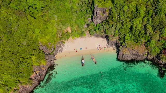 Aerial drone landscape bay turquoise lagoon Nui beach sunny day with long tail boat koh Phi Phi Don island Krabi Thailand