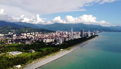 Cityscape panorama of a coastal town, mountains in the background