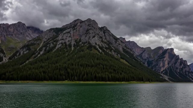 emerald-bodied body of water situated amidst peaks on overcast day