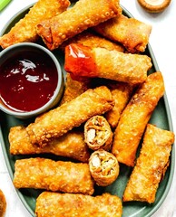 Crispy Egg Rolls with Sweet Chili Sauce on a Teal Plate