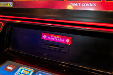 Casino slot machine card slot with illuminated instruction sign