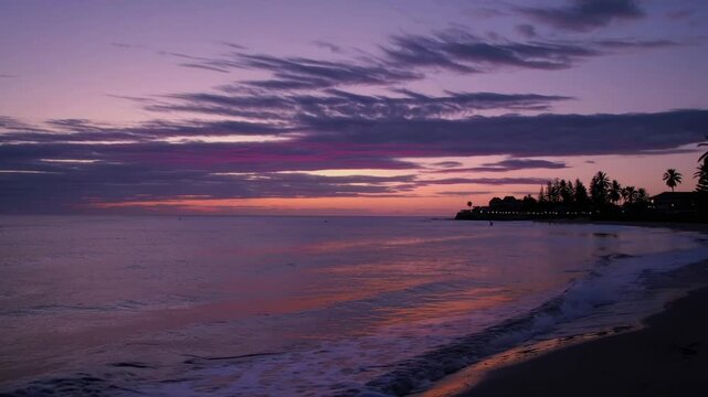 beautiful sunset at Orewa Beach in Auckland, New Zealand, with pink and orange hues in the sky