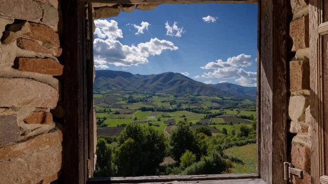 View of Green Valley and Mountains in the Italian Region Through Open Window