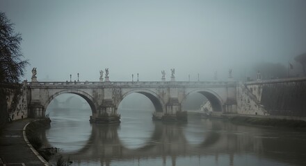 Fototapeta premium Ancient bridge in rome shrouded in atmospheric mist creating a ghostly ambiance
