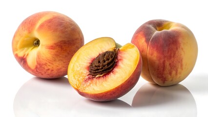 Two Peaches and One Halved Peach with Pit on White Background fruit whole