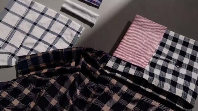 Neatly Folded Napkins, Kitchen Towels, and Tablecloths Arranged in Top-Down Angle View