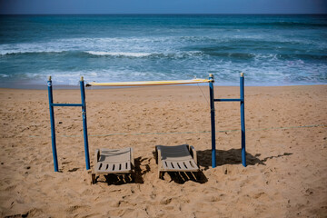 Empty Sun Loungers and Umbrellas on a Sandy Beach