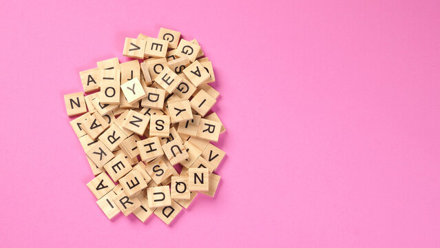 wooden letter cubes isolated on pink background