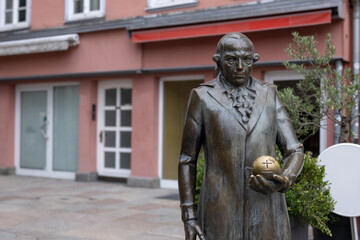 Bronze sculpture of famous German scientist Carl Friedrich Gauss standing with orb in Göttingen