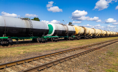 Naklejka premium Railway tank cars used to transport petroleum products. . Identification markings have been removed. The fuel train with petrochemical tank cars.