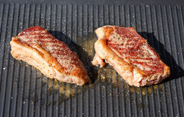 freshly grilled beef striploin steaks