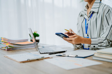 Female office worker working with financial reports for tax audit reports or financial statement in...