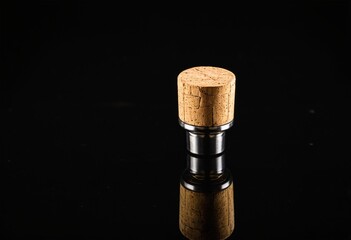 A close up of a cork on a black surface.